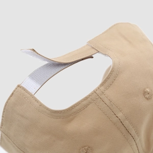 Detail of khaki cotton baseball cap showing adjustable hook-and-loop back strap
