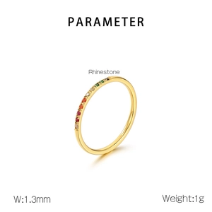 Detail view of 1.3mm slim gold ring featuring colorful rainbow gradient rhinestones