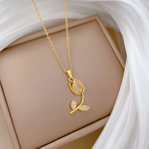 Elegant gold tulip pendant necklace with mother of pearl and zircons in a jewelry box