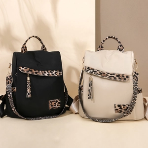 Fashionable Oxford leopard print patchwork backpacks in black and beige with fringe charms
