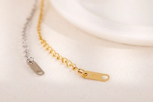 Detailed macro view of 14K gold and silver steel extension chain tags for bracelets