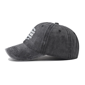 Detail view of washed black cotton baseball cap with AGT MY AGE embroidery and side print