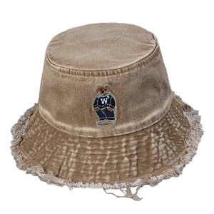 Vintage washed tan denim bucket hat with embroidered bear and frayed edge details