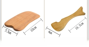 Close-up of natural sandalwood gua sha massage tools with smooth polished textures