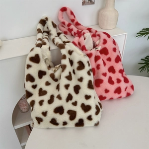 Detail of plush heart tote bags showing soft faux fur texture and magnetic snap closure