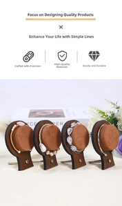 Detail of walnut wood jewelry display stands with round brown velvet pads for bracelets