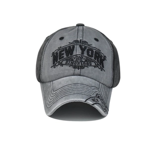 Close-up of black NEW YORK embroidery on vintage washed grey cotton baseball cap