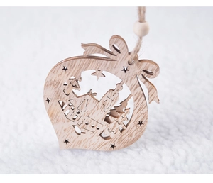 Macro detail of natural wood Christmas ornament with hollowed tree and house carvings
