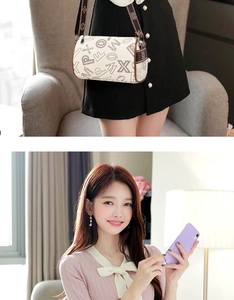 Chic beige cylindrical crossbody bag with black lettering and brown strap on a model