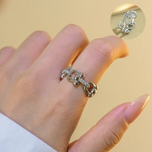 Macro detail of U-shaped horseshoe ring featuring full pavé zircon stones and silver finish