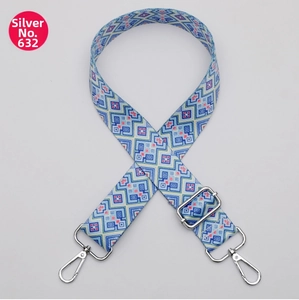 Detail of blue and white ethnic geometric pattern wide strap with silver metal buckle