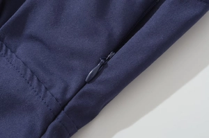 Macro shot of invisible zipper and fine stitching on navy blue vintage dress fabric