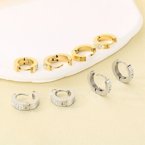 Polished gold and silver hoop earrings with micro-pave crystals on display