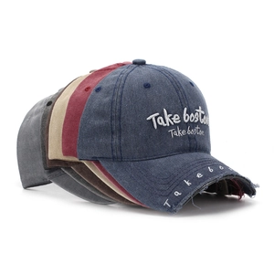 Multiple vintage washed cotton baseball caps with Take Boston embroidery and distressed details