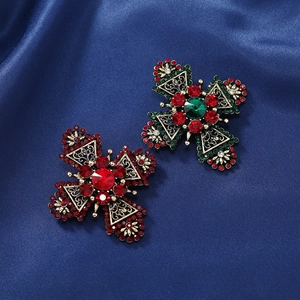 Vintage gold cross brooches with red and green rhinestones on dark blue silk