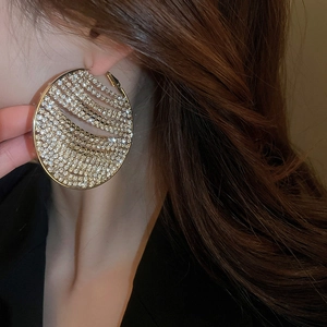 Chic gold-plated geometric circle earrings with zircon stones on a female model