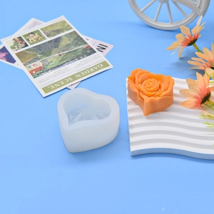 3D heart rose silicone mold for DIY candles and soaps on a blue background