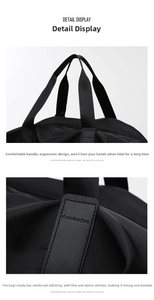Detail of reinforced handles and leather logo on black waterproof travel fitness bag