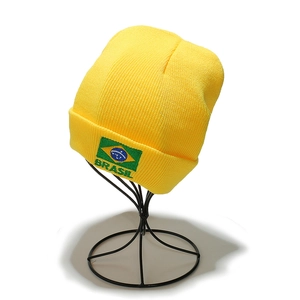 Detail of embroidered Brazil flag and BRASIL text on yellow knit beanie cuff