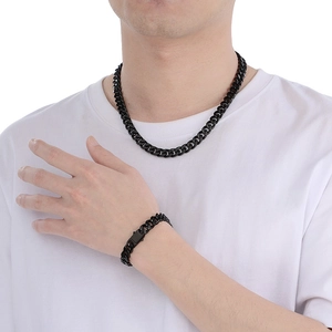 Polished black Cuban link chain necklace and bracelet set displayed on a male model