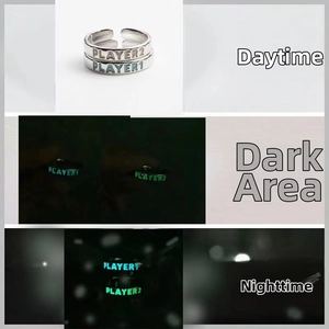 Luminous PLAYER 1 and PLAYER 2 rings showing glowing effect in different lighting
