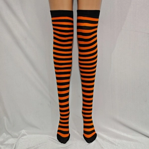 Close-up of black and orange striped over-the-knee socks for festive costumes