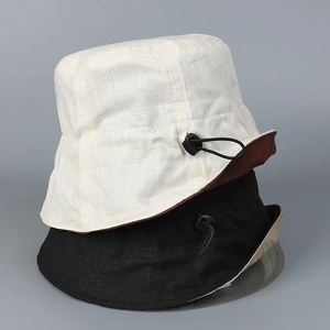 Detail of linen sun hat with adjustable drawstring and breathable natural fiber texture
