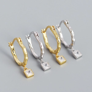 Detailed view of S925 sterling silver irregular wavy hoop earrings with crystal pendants