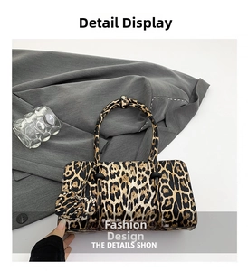 Detail showing leopard print handbag with metal rivets and heart-shaped bag charm