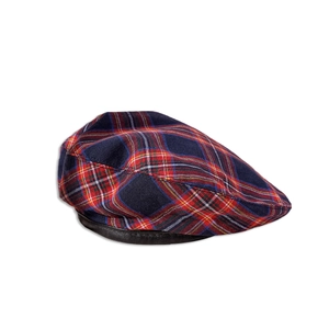 Détail du béret à carreaux rouges montrant le motif tartan et le bord en cuir noir