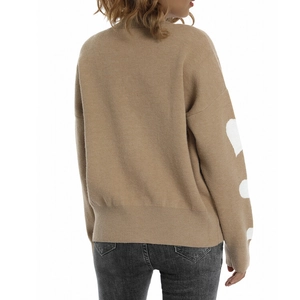 Rear view of camel knit sweater featuring large white heart patterns on long sleeves
