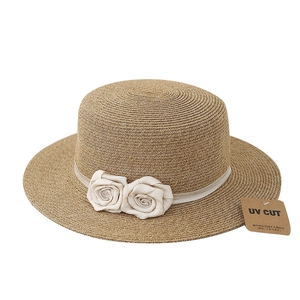 Flat top straw sun hat with rose ribbons and UV protection features for women