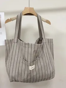 Large capacity striped canvas tote bag with shoulder straps and front pocket for women