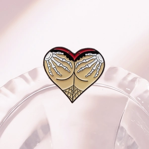 Creative Halloween heart enamel pin featuring a skeleton hand and butt illustration