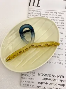 Detail of 13cm large hair claw clip with blue to yellow gradient and strong metal spring