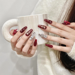 Press-on nails with red base, golden dragon patterns and 3D bows for New Year