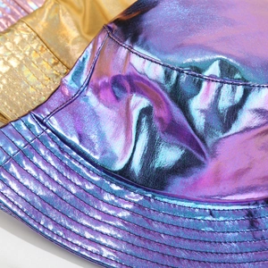 Macro shot of metallic laser PU bucket hats showing textured colorful reflective fabric