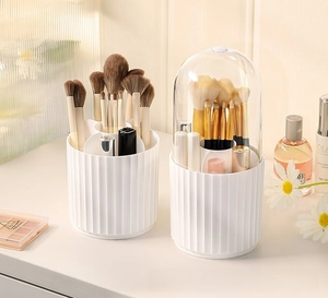 Macro shot of white rotating makeup brush holder with 6-compartments and vertical stripes