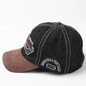 Detail of vintage baseball cap featuring denim fabric, suede brim, and 2001 embroidery