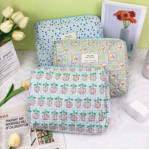 Three-piece set of quilted floral toiletry bags with zipper and cotton fabric design