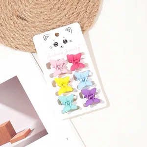 Close-up of 6 colorful matte butterfly hair clips on a fashion jewelry display card