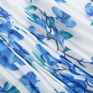 Macro shot of elegant blue floral pleated fabric with detailed texture and light blue petals