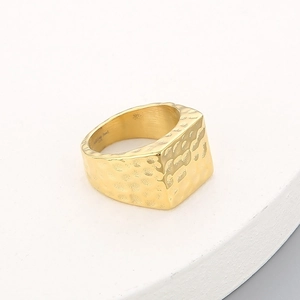 Macro shot of 18K gold plated stainless steel ring with hammered square surface detail