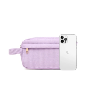 Close-up of light purple corduroy makeup bag with gold zipper and side carry handle
