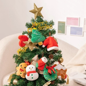 Close-up of plush gingerbread man and snowman ornaments on a decorated Christmas tree
