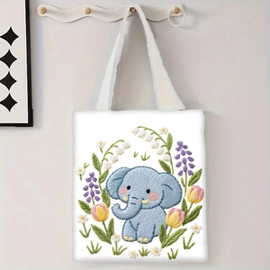 Détail du sac cabas en toile blanche avec motif éléphant bleu et broderies florales