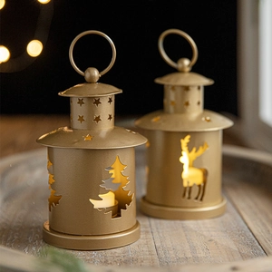 Golden Christmas tea light lanterns with reindeer and tree cutouts on wooden tray
