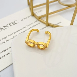 Detail shot of a gold glasses-shaped ring with pavé cubic zirconia and adjustable band