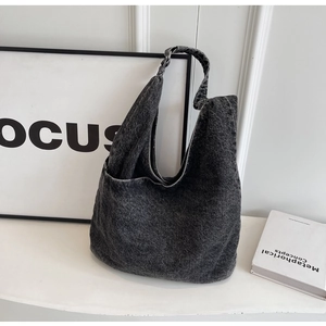 Deep grey washed denim shoulder bag with a minimalist slouchy design and wide strap