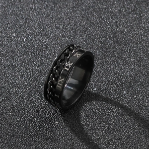 Detailed macro shot of a black stainless steel rotating ring with Roman numerals and chain